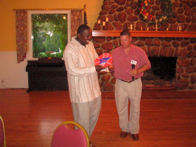 Ibn Gaskins receiving the "Classmate who came the farthest" Award (Brooklyn) from Master of Ceremonies: Roger Fincher